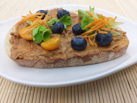 Bread slice with peanut butter and blueberries