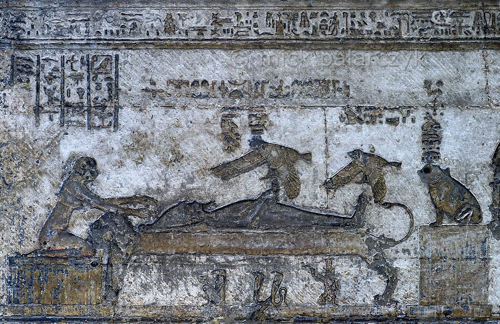 The conception relief, Aset in the form of a bird above the body of Asar on the bier — the oldest surviving image of Heru's conception.