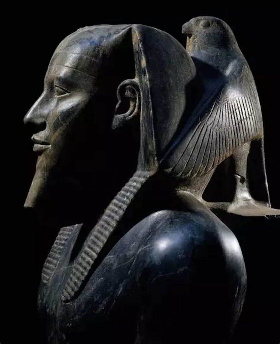 — Heru as the protector of kings: the god's wings wrap the back of the pharaoh's head, Fourth Dynasty.