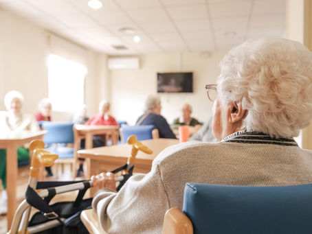 elderly people sitting at a nursing home