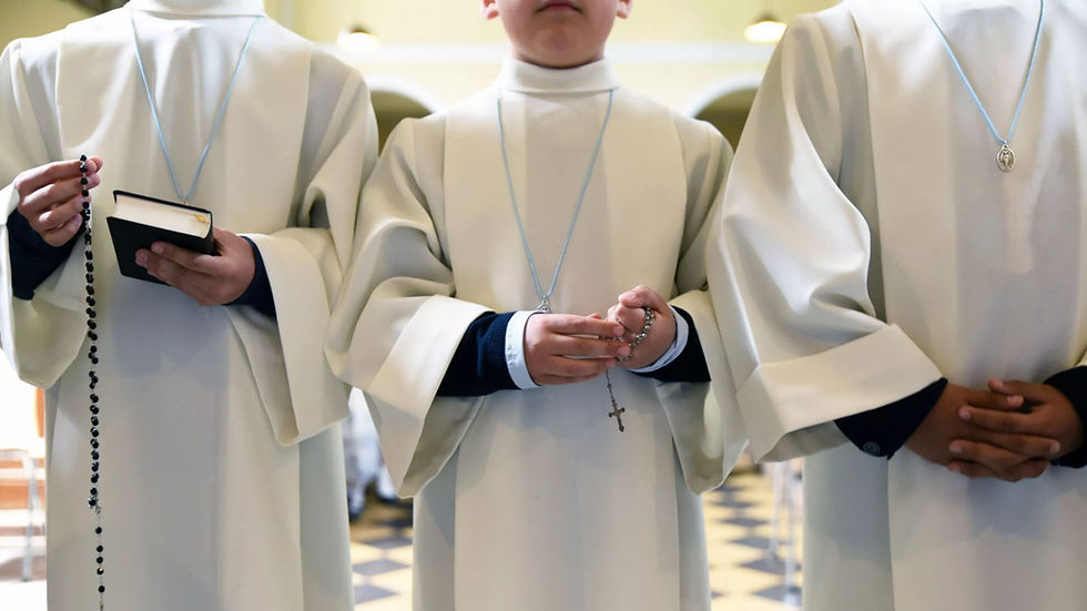 3 boys in white robes with rosaries