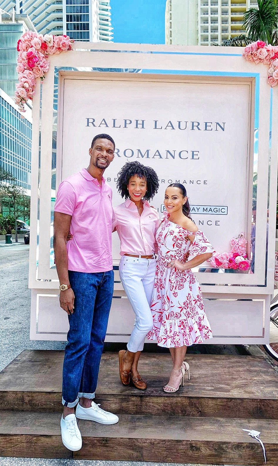Basketball player Chris Bosh, his wife Adrienne & model Kamla-Kay outside by Ralph Lauren event truck