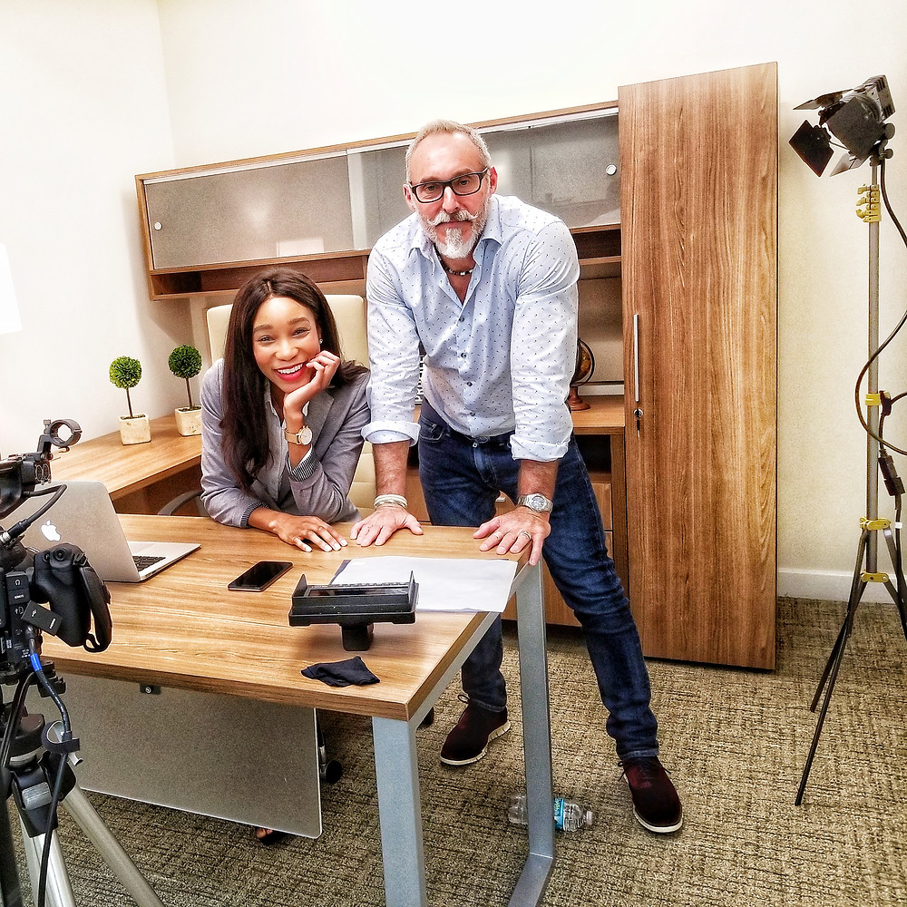 man and woman Kamla-Kay at office desk with camera equipment