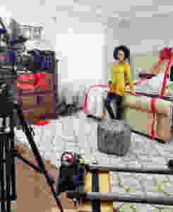 model woman Kamla-Kay on set tv commercial with camera in bedroom