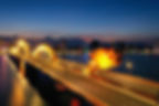 Dragon Bridge at night, glowing with vibrant lights and showcasing its spectacular fire and water performance over the Han River.