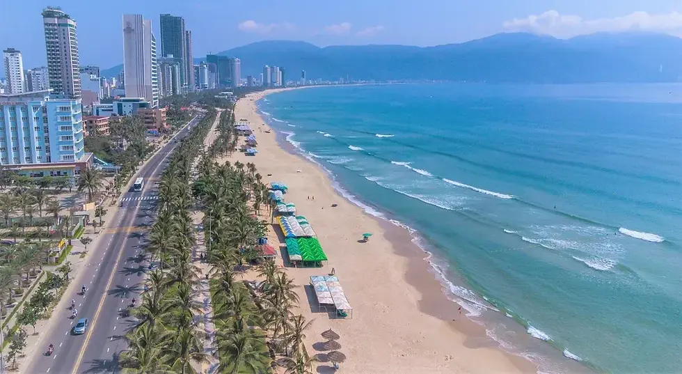 Beautiful My Khe Beach with white sand, clear blue water, and palm trees in Da Nang