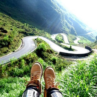 Panoramic view of Ha Giang showcasing majestic mountains, valleys, and winding roads.
