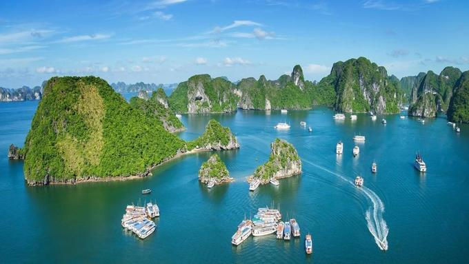 Boats are bustling with activity in Ha Long Bay during the summer season.