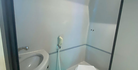 Clean onboard toilet inside VIP cabin bus to Da Nang for passenger convenience.