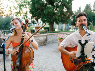 cello and guitar player play live music during a wedding reception in italy
