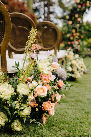 the luxury wedding aisle is lined with colorful flowers