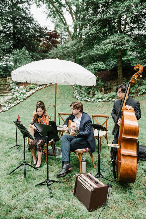 the string trio prepares for the ceremony