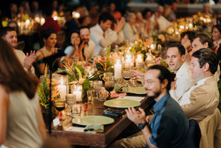 guests enjoy speeches during a family-style feast