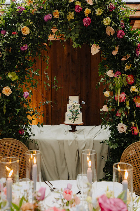 wedding reception with draping on the cake table. cake has lace like the bride's dress
