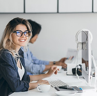 attractive-laughing-freelancer-woman-posing-with-cup-coffee-her-workplace-chinese-student-