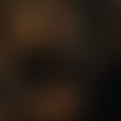 A person sits at a table during a conversation, smiling faintly but with a distant, tired expression—hands gently folded in front of them. The mood is subdued, reflecting the quiet emotional cost of unspoken boundaries.