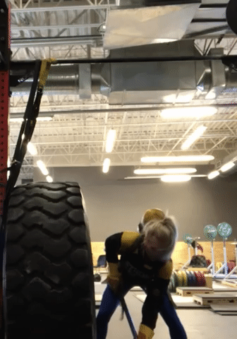 Haley Fanning, a dynamic and determined athlete and coach, demonstrates her prowess in FireFit, a challenging and intense fitness competition inspired by the physical demands of firefighting. Clad in specialized gear, she maneuvers through a grueling obstacle course, showcasing her strength and agility. The image captures Haley's focused expression and powerful movements as she conquers each obstacle with precision and determination, highlighting her dedication to peak physical performance in this demanding athletic discipline.