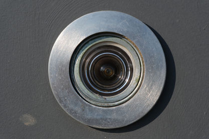 Close-up of a metallic security camera lens