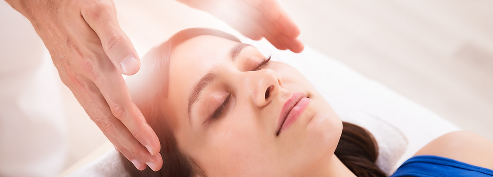 A woman receiving a therapeutic touch treatment