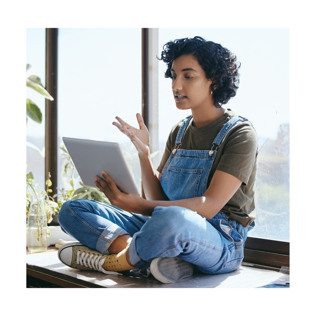 Girl sitting with laptop engaged in virtual discussion