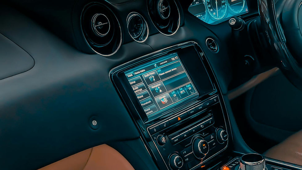 Close-up of luxury car interior showcasing dashboard, controls, and touchscreen display.