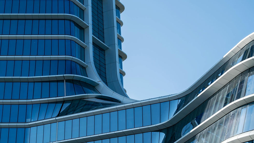 Close-up of a modern glass facade featuring curvilinear design elements, highlighting urban architecture.