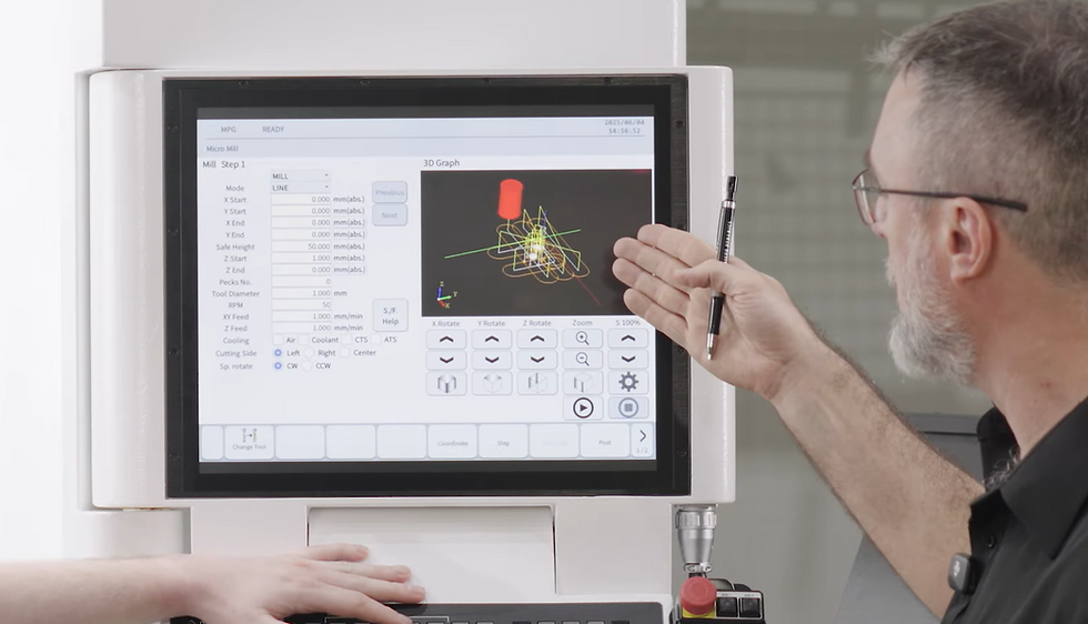 A man pointing at Micro Dynamics HMI MICRO MILL screen on a Mega 30V
