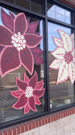 Window mural of burgundy and pink poinsetta flowers