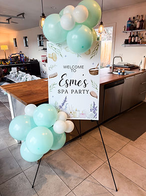 Welcome sign with balloon décor at a luxury kids spa and sleepover party in Boulder, Colorado, featuring styled details and personalized signage by Katie's Party Lab.