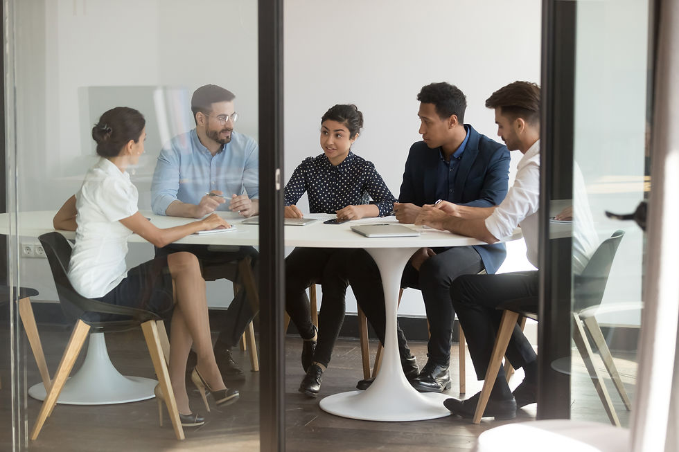 Businesspeople-sitting-at-table-in-boardroom-listens-indian-team-leader-1174262736_6223x41