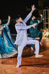 Roban performing a dance on the Sangeet dance floor at night at Hard Rock Los Cabos