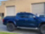 Blue ute with a fitted black tonneau cover