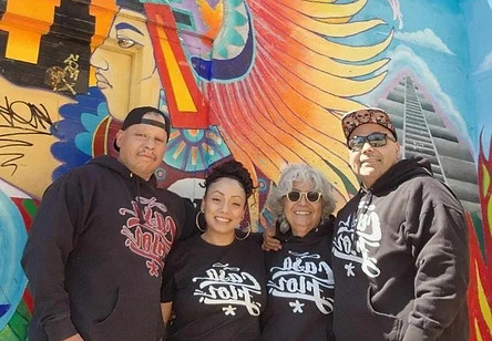 Friends standing in front of a wall mural