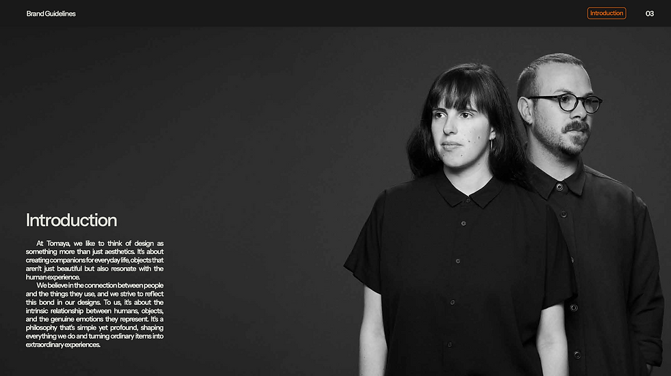 Two people in dark shirts stand side by side on a gray background. Text on the left reads "Introduction" with details about Tomaya's design philosophy.
