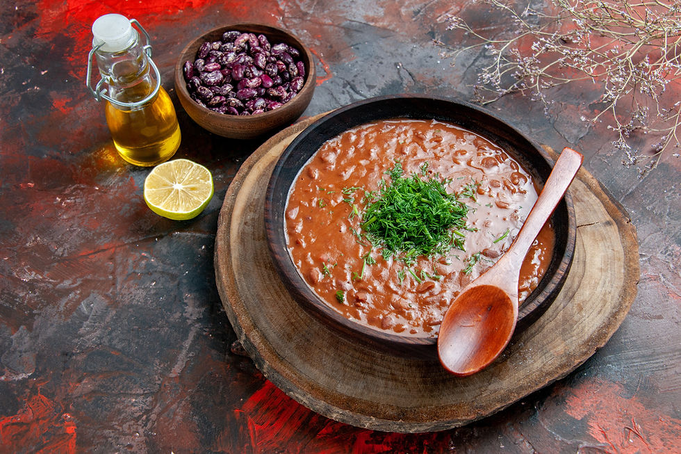A steaming bowl of traditional Latin bean soup seasoned with cumin and cilantro, celebrating Latin culture and rich in fiber to support gut health.