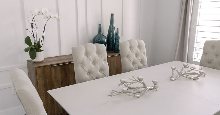 modern table with 4 beige chairs and a brown side table