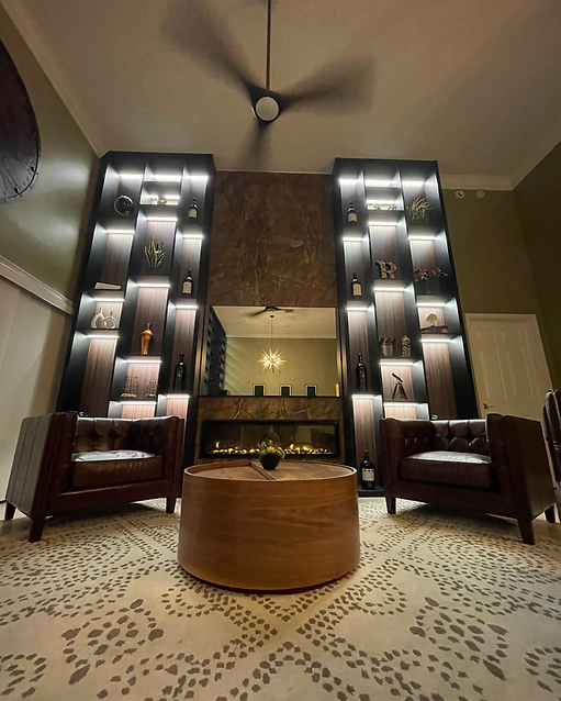 Custom shelving with underlighting and a mirror tv in the middle