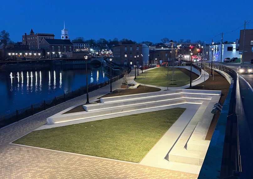 Commercial landscape lighting featuring integrated LED strip lights under concrete park steps.