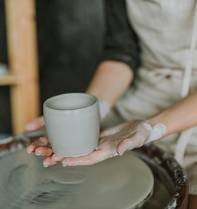 person holding pottery