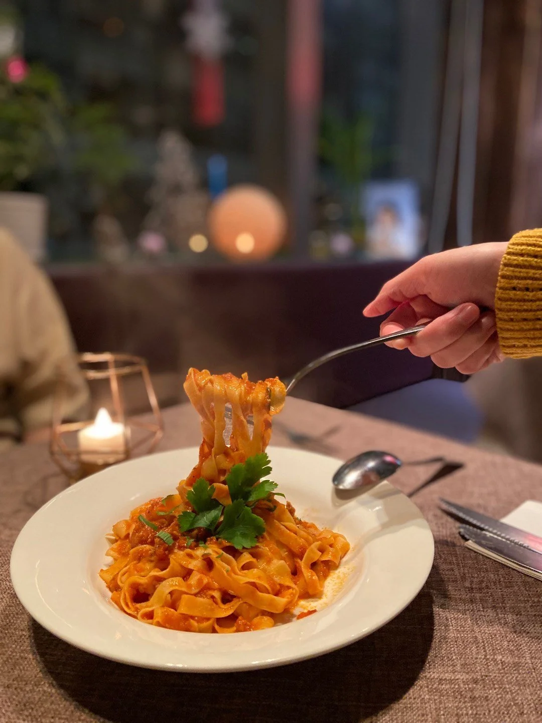 Classic Italiab basil tomato pasta being lifted up with a fork.