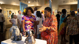 artists discuss a sculpture in the art exhibit