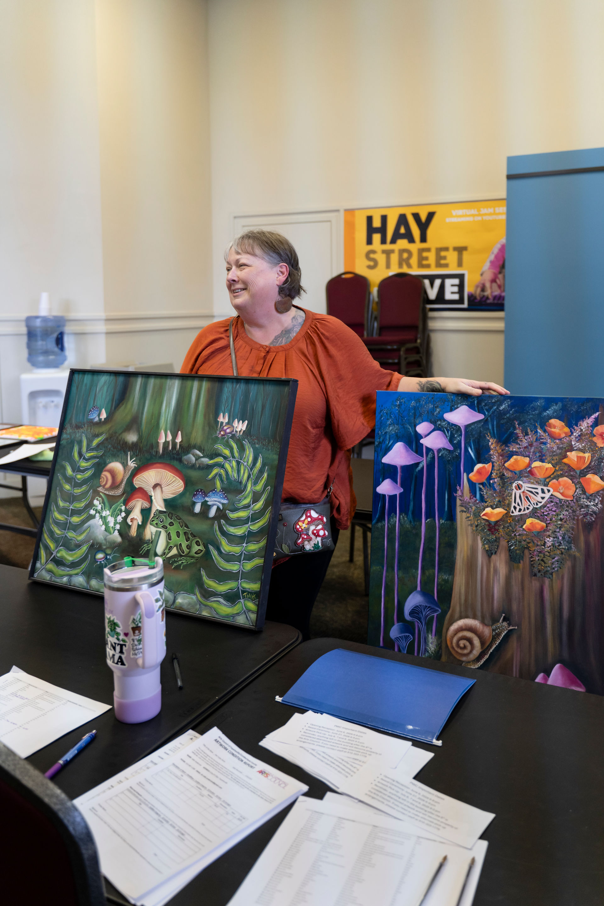 Artist drops off her paintings for the Public Works exhibit