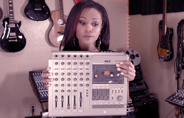 Renne Meejah holding her Tascam 424 Portastudio cassette machine