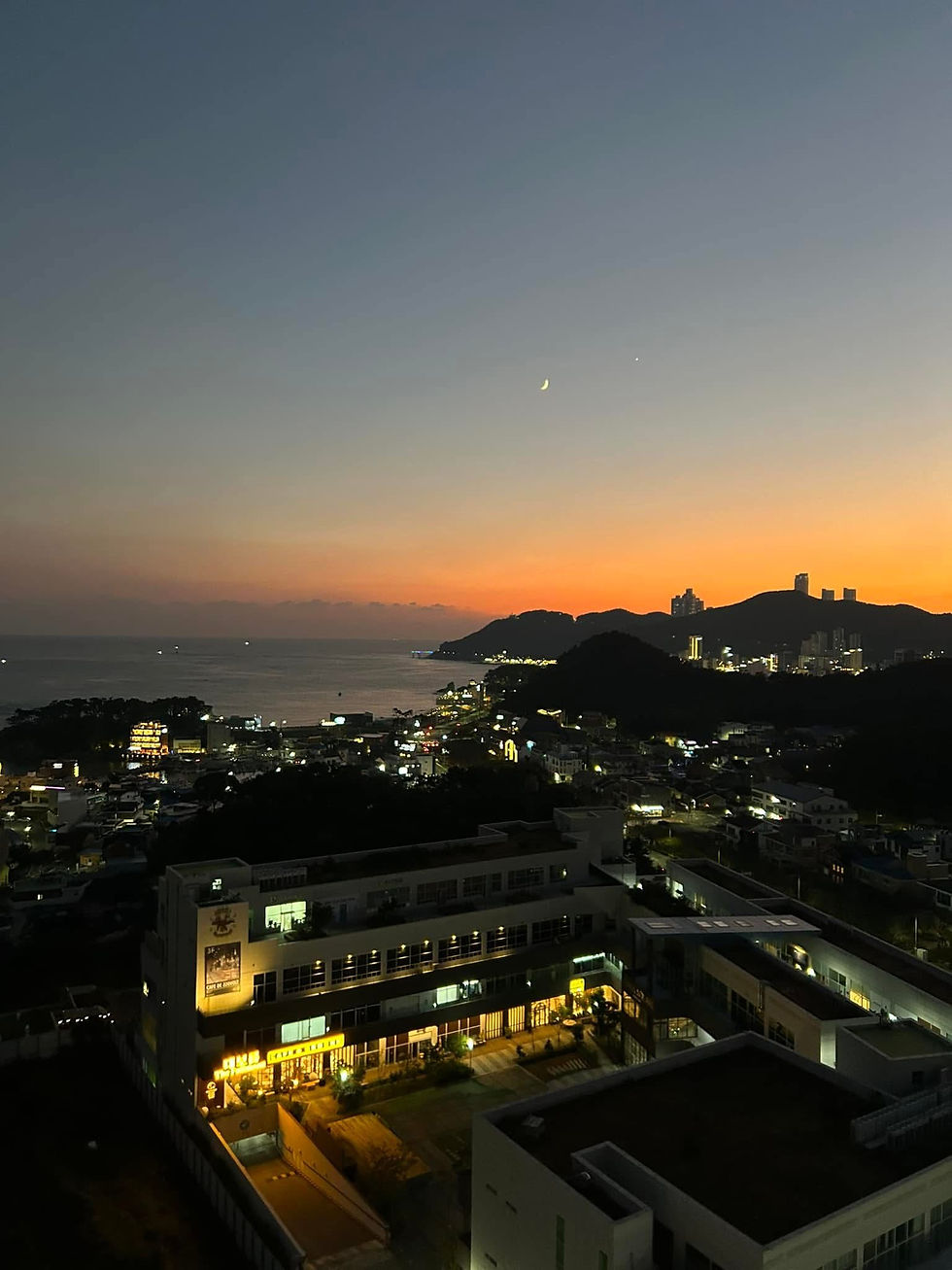 Crescent moon over the ocean at dusk in Gijang Busan Korea