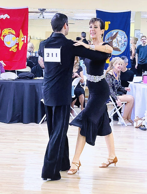 Ballroom dance competition at Fatcat Ballroom Phoenix with student and instructor performing in elegant attire