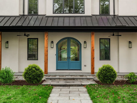modern home exterior with arched doorway