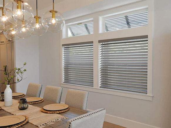 Grey faux wood blinds in dining room with modern decor and filtered natural light
