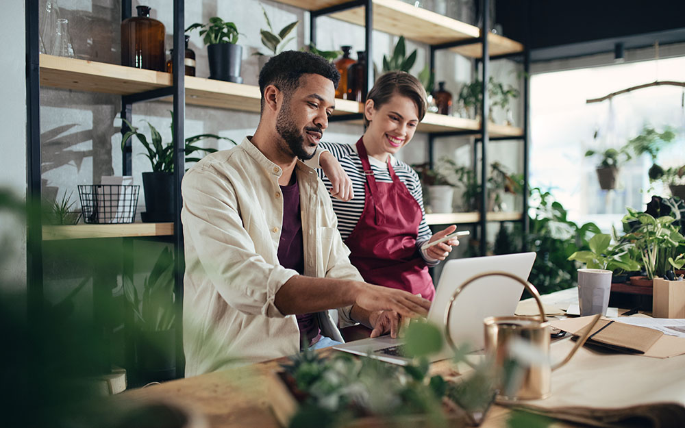 Small business owners in a cafe setting, exemplifying the diverse SME clientele served by Orbit Coaching and Consulting.