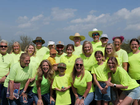 Skyview Vacations team wearing matching neon green shirts at Skyview Ranch.