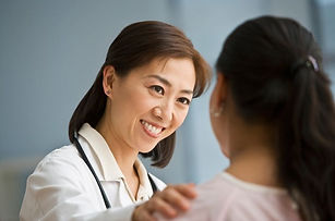 A lady nurse talking to a woman